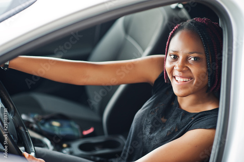 Portrait of young african american woman driving a car. © AS Photo Family