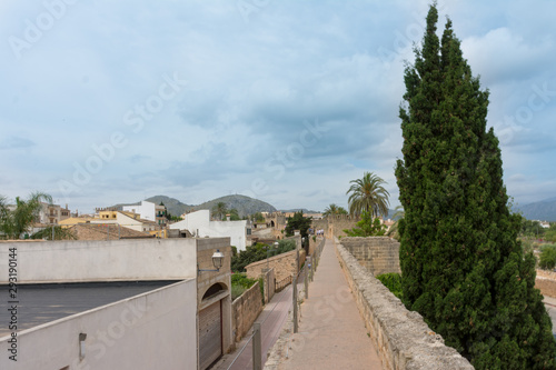 Alcudia. Tourists walk on the city wall