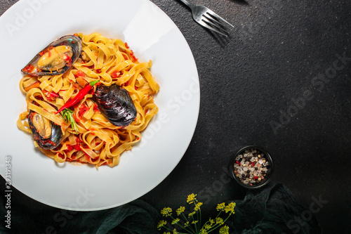 pasta with mussels (tagliatelle seafood) menu concept. food background. copy space. Top view