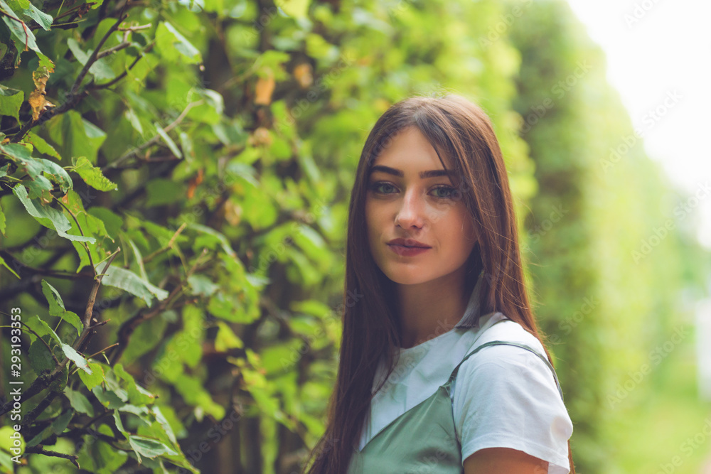 Romantic portrait of fashion beautiful autumn woman model with brown hair. Pretty woman with perfect skin and eyes in the park. Romantic portrait of fashion beautiful autumn woman model with brown hair. Pretty woman with perfect skin and eyes in the park.