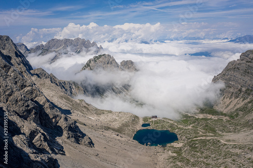 Mountain peaks above clouds, Dolomites, Lienz, Austria photo