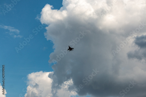 military aircraft flying in the background of clouds