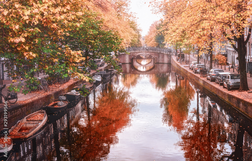 Amsterdam canal with its bridges in beautiful fall colors in the old center of Amsterdam