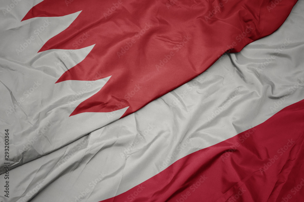 waving colorful flag of poland and national flag of bahrain.