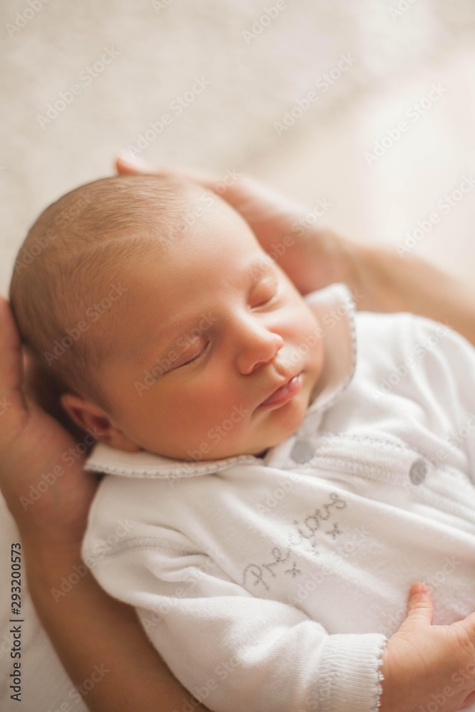 Cute newborn baby sleeping in mother's arms. Motherhood. Cute newborn baby sleeping in mother's arms. Motherhood.