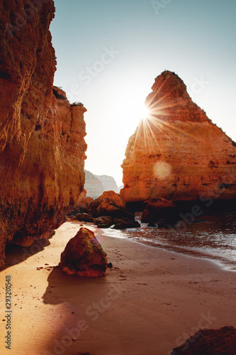 Beautiful sunrise view of a empty beach with rough sand stone rock coastline and nature view. Praia da Marinha, Famous Beach, Algarve Coast in South Portugal, Atlantic Ocean photo