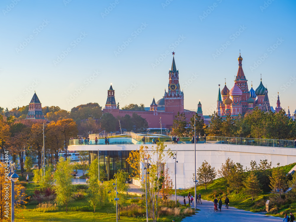Beautiful view of Zaryadye landscape park with the steeples of the Kremlin and the St Basil`s Cathedral in the background on a sunny autumn evening. Beautiful view of Zaryadye landscape park with the steeples of the Kremlin and the St Basil`s Cathedral in the background on a sunny autumn evening.