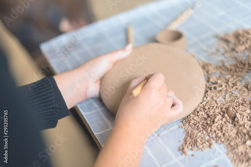 Pottery workshop  the process of making ceramic tableware  women s hands