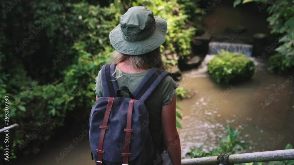 Young beautiful woman walking up the stairs in the jungle. Happy tourist girl on vacation. Lifestyle backpack tourist travel alone on holiday. An independent female researcher in Asia. Young beautiful woman walking up the stairs in the jungle. Happy tourist girl on vacation. Lifestyle backpack tourist travel alone on holiday. An independent female researcher in Asia.
