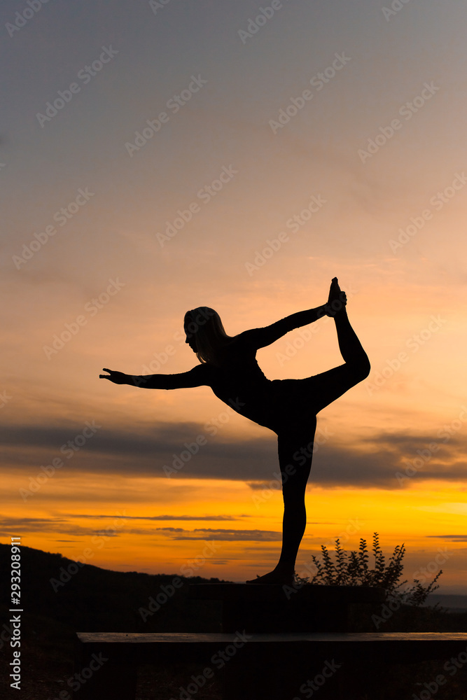 Silhouette woman coach yoga practice at sunset. Yoga concept.