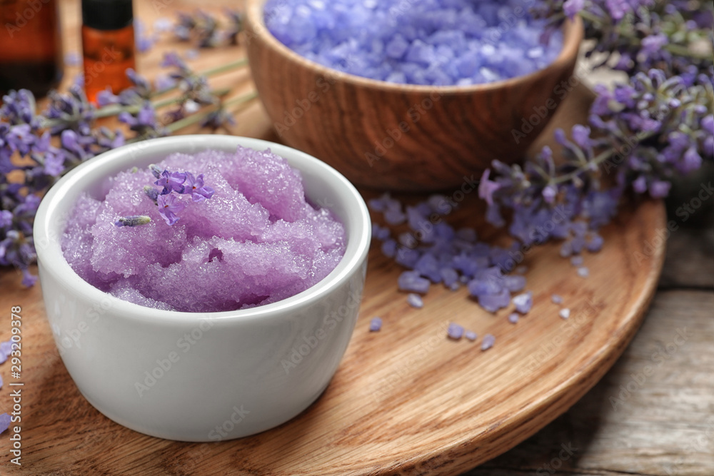 Composition with natural sugar scrub and lavender flowers on wooden table. Cosmetic products Composition with natural sugar scrub and lavender flowers on wooden table. Cosmetic products