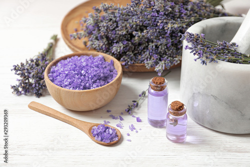 Composition with natural cosmetic products and lavender flowers on white wooden background