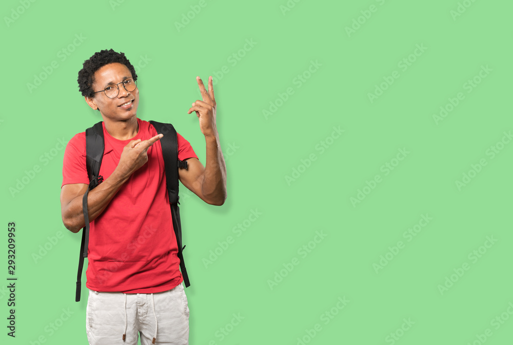 Young man making a number two gesture Young man making a number two gesture