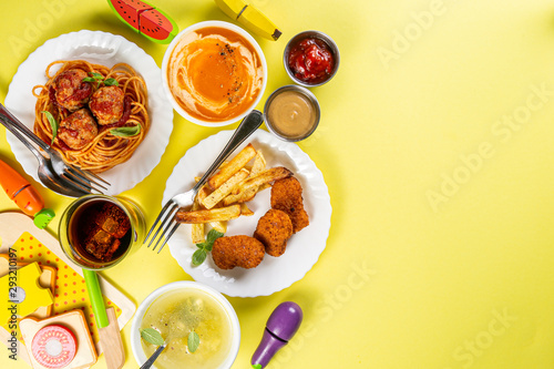 Kids menu concept - pasta, nuggets, french fries, soups, cola top view