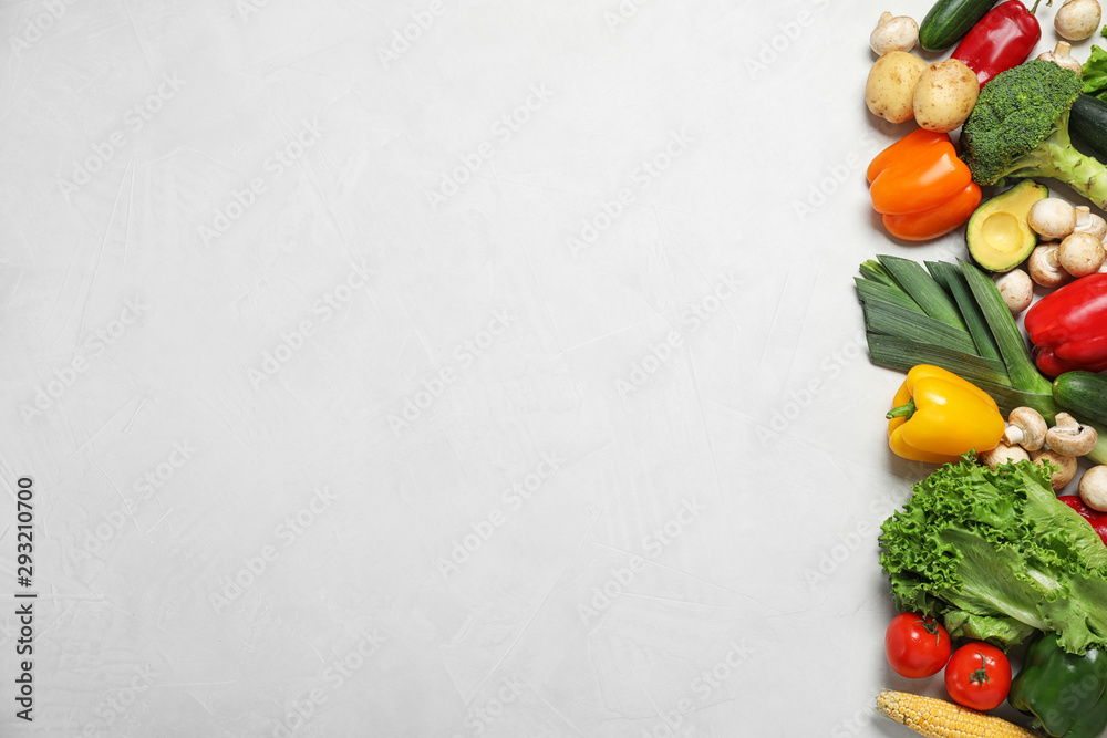 Fresh vegetables on light grey background, flat lay. Space for text
