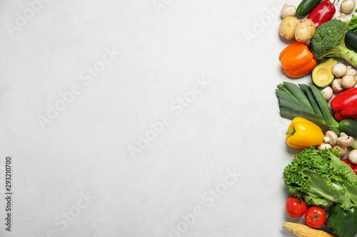Fresh vegetables on light grey background, flat lay. Space for text
