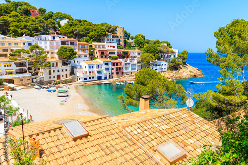 View of beach in Sa Tuna fishing village with colorful houses on shore, Costa Brava, Catalonia, Spain photo