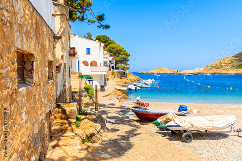 Fishing boats on beach in Sa Tuna village with colorful houses on shore, Costa Brava, Catalonia, Spain photo
