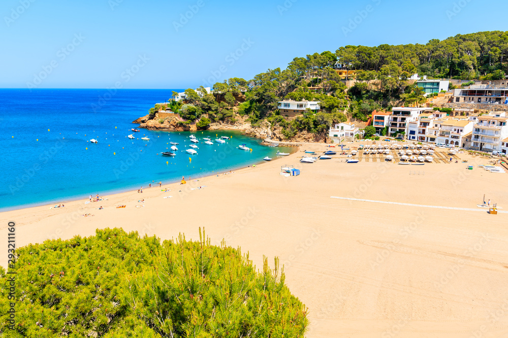 Obraz premium View of sandy beach in Sa Riera coastal fishing village, Costa Brava, Catalonia, Spain