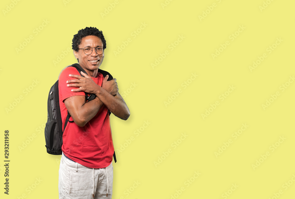 Concerned young man making a gesture of being cold Concerned young man making a gesture of being cold