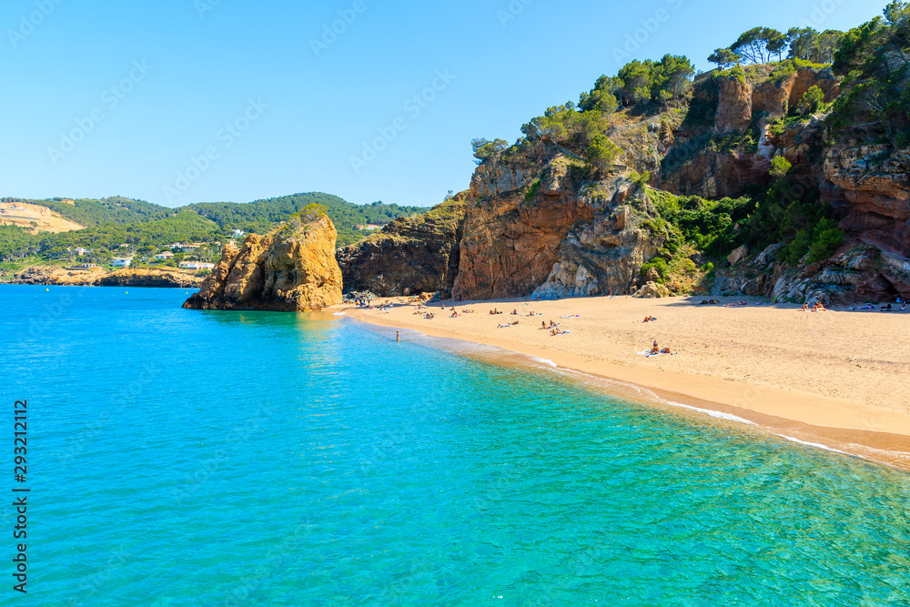 Azure blue sea water at Cala Moreta beach and view of rocks, Costa Brava, Catalonia, Spain