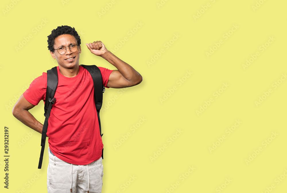 Serious young man making a gesture of strength Serious young man making a gesture of strength