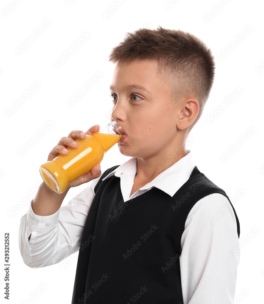 Fototapeta premium Little boy drinking juice on white background