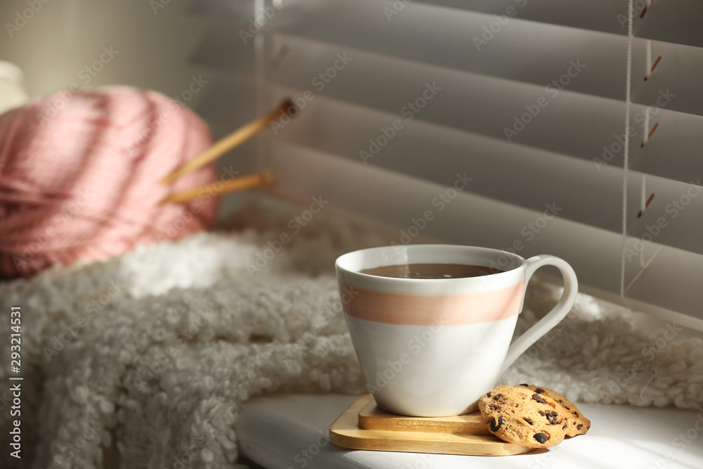 Cup of hot winter drink and cookies on windowsill indoors. Space for text Cup of hot winter drink and cookies on windowsill indoors. Space for text