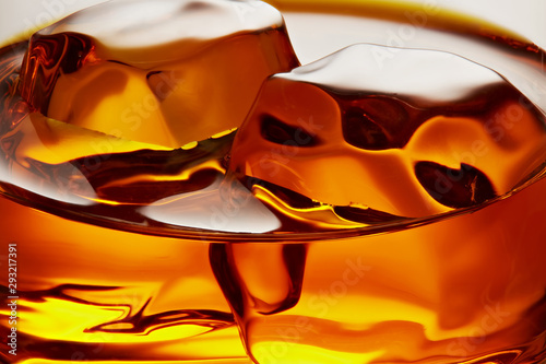 Glass of elegant whiskey with ice cubes photo