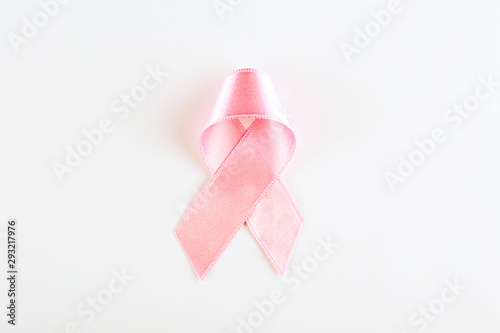 The pink colored ribbon - international symbol of breast cancer awareness and moral support for women. Isolated background, copy space, close up, top view fat lay.