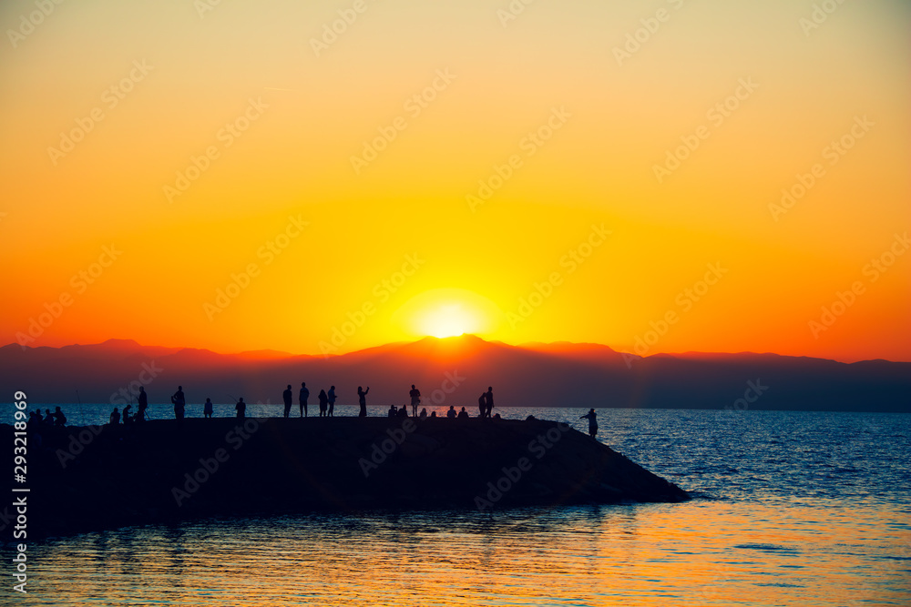 Naklejka premium People enjoying sunset