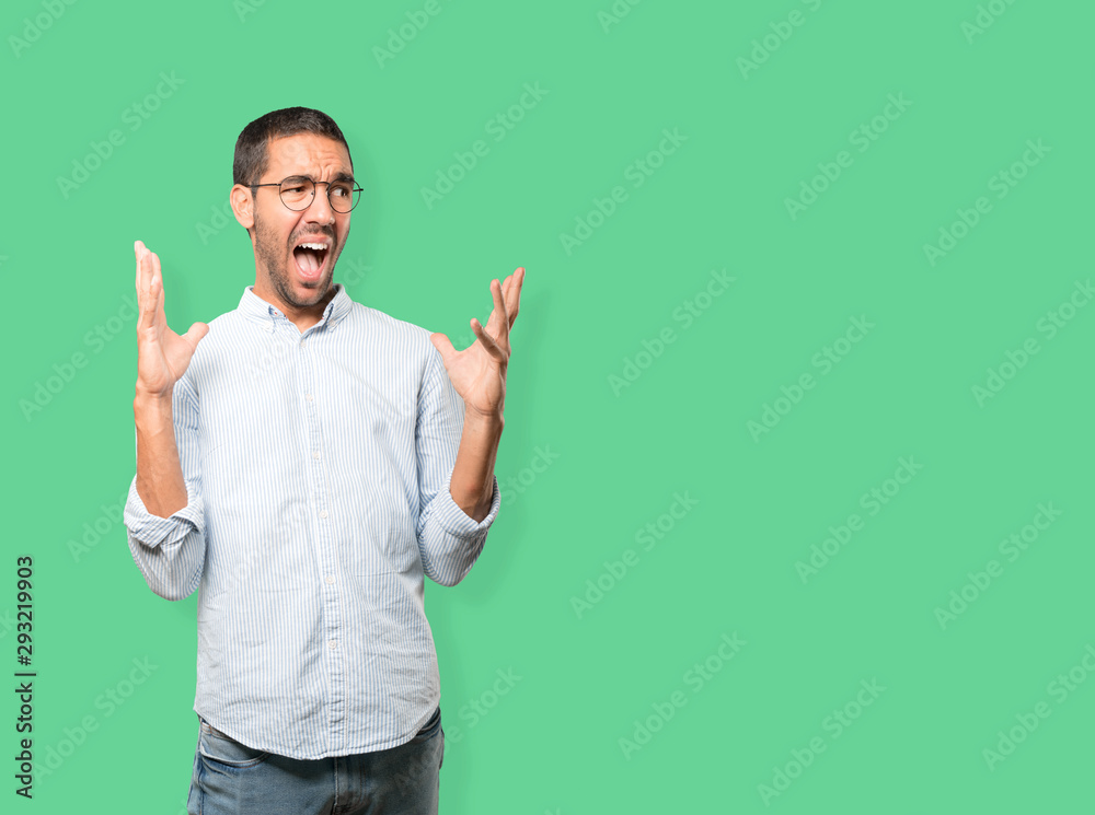 Crazy young man making a gesture of despair Crazy young man making a gesture of despair