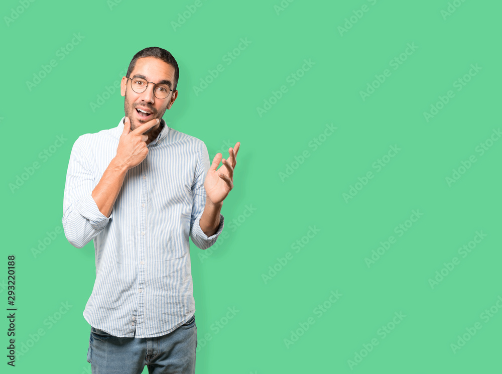 Surprised young man making a gesture of doubt Surprised young man making a gesture of doubt