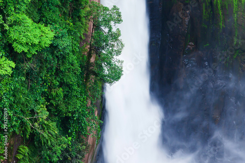 Aerial view of the grand waterfall in tropical ravine.