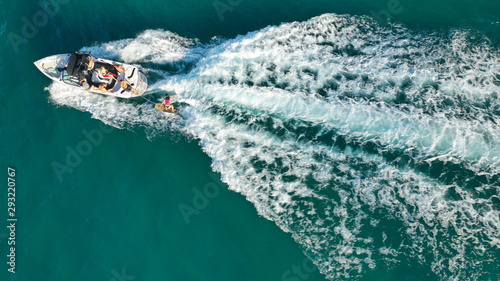 Tableau sur toile Aerial photo of woman practising waterski in Mediterranean bay with emerald sea
