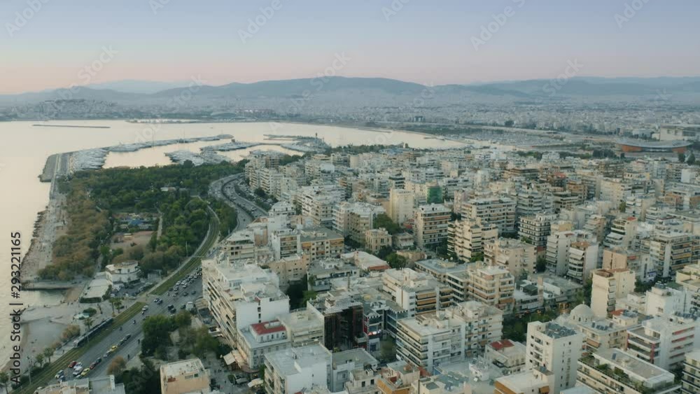 Aerial shot of coastal districts of Athens and distant city of Piraeus in the evening, Greece Aerial shot of coastal districts of Athens and distant city of Piraeus in the evening, Greece
