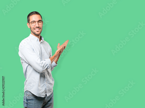 Friendly young man making a gesture of welcome