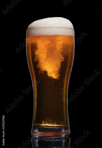 Glass of beer isolated on black background.