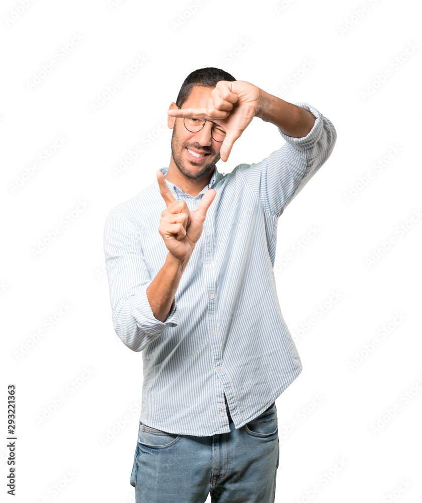 Friendly young man making a gesture of taking a photo with the hands Friendly young man making a gesture of taking a photo with the hands