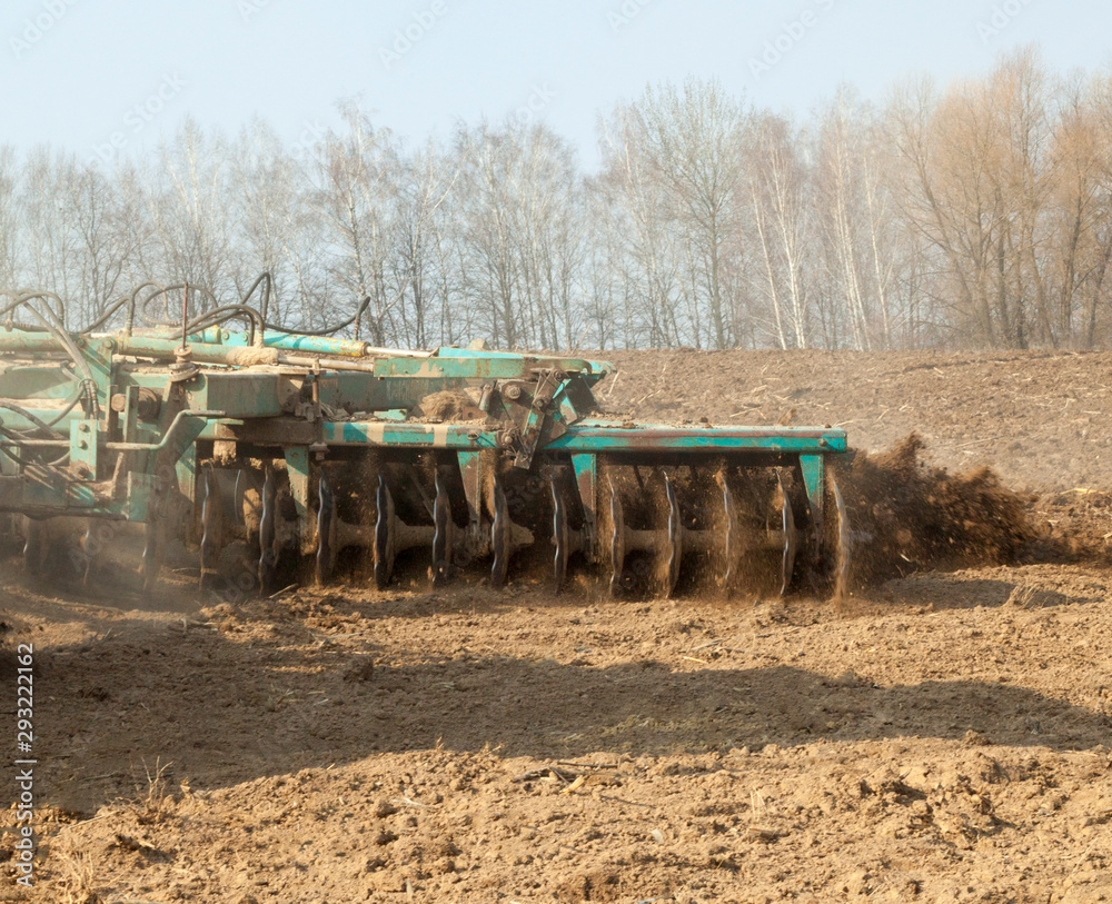 Obraz premium Harrowing the soil with disc harrows