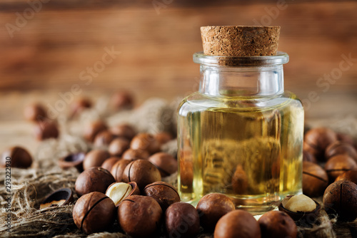 macadamia oil in glass with macadamia nuts