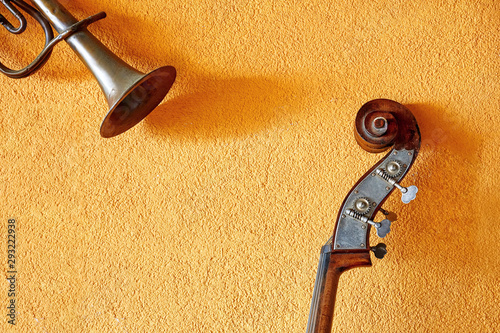 Photography Vintage trumpet and double bass against the yellow wall background