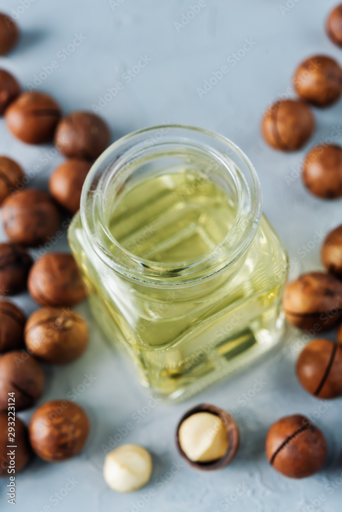 macadamia oil in glass with macadamia nuts macadamia oil in glass with macadamia nuts