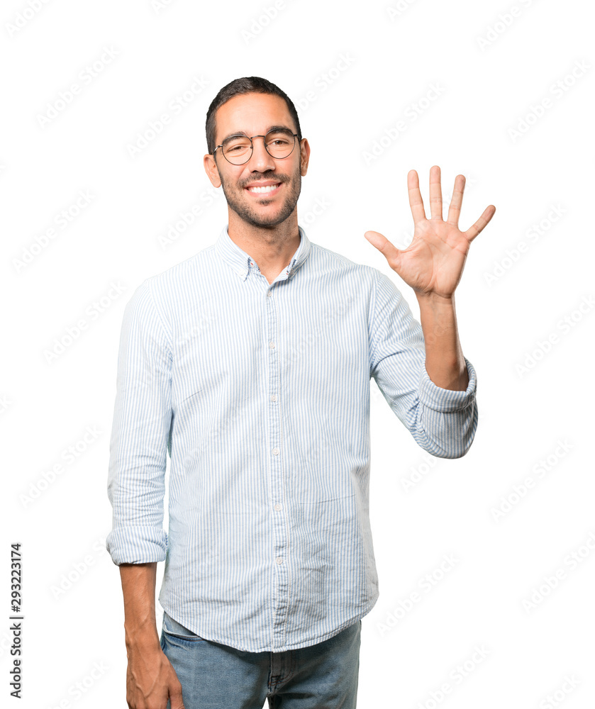 Young man making a number five gesture Young man making a number five gesture
