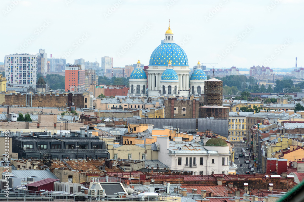 Cityscape view of the city of Saint Petersburg, Russia. in the midst of many roofs emerge the colorful blue domes of the famous Trinity Cathedral