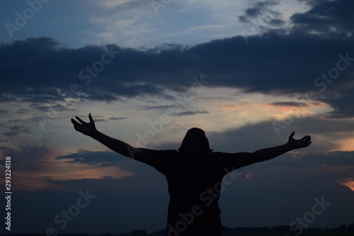 silhouette of young woman in sunset
