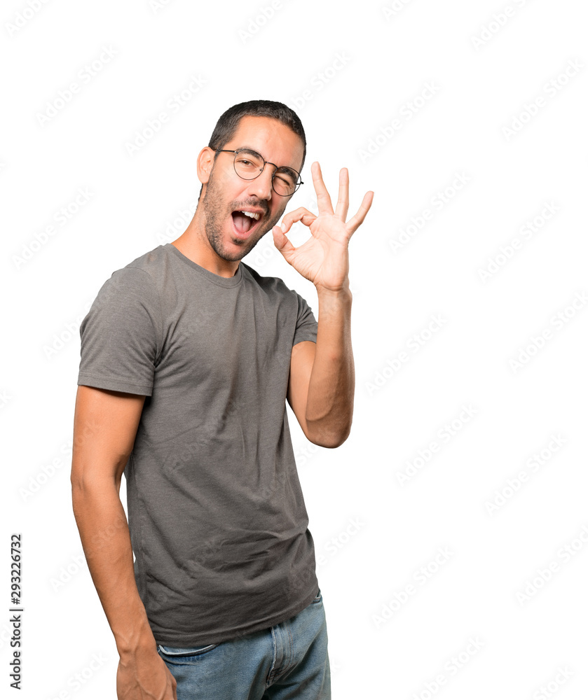 Surprised young man with a gesture of approval