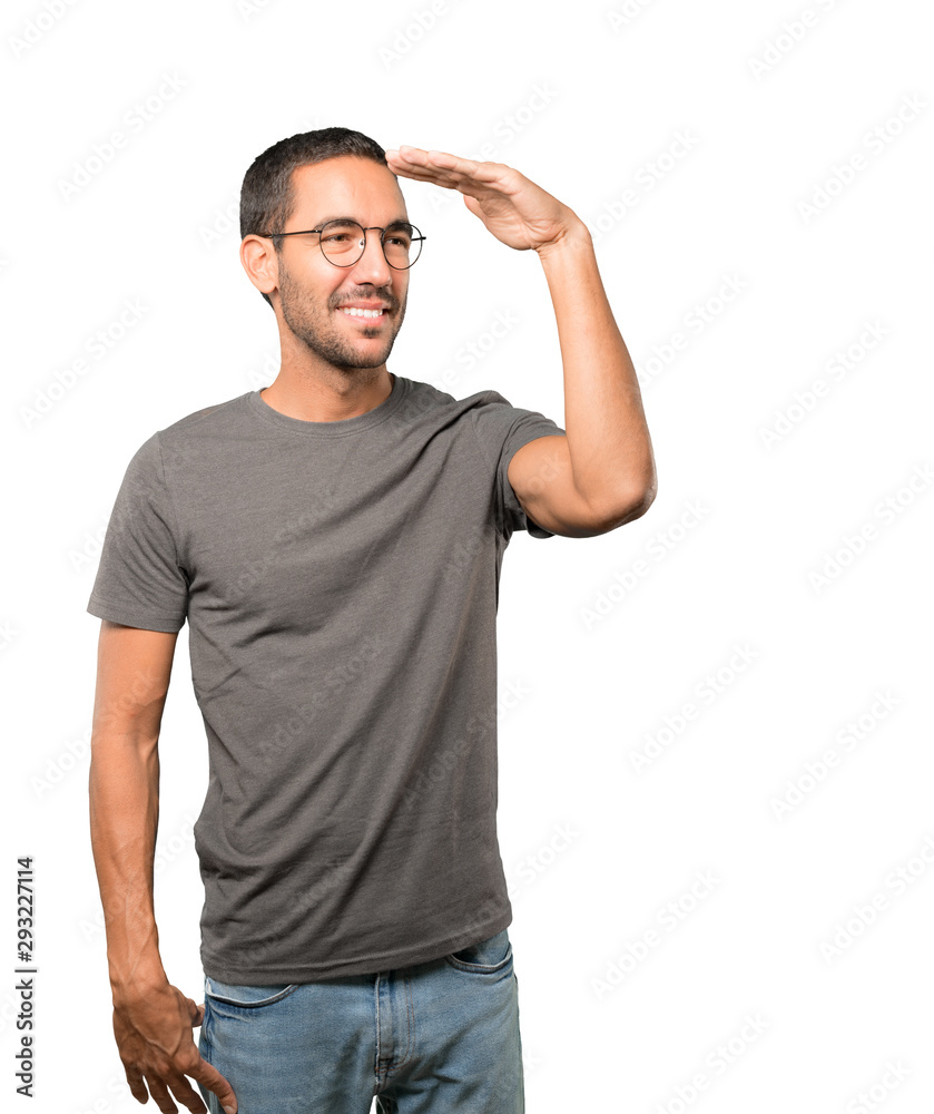 Happy young man with a gesture of looking away Happy young man with a gesture of looking away