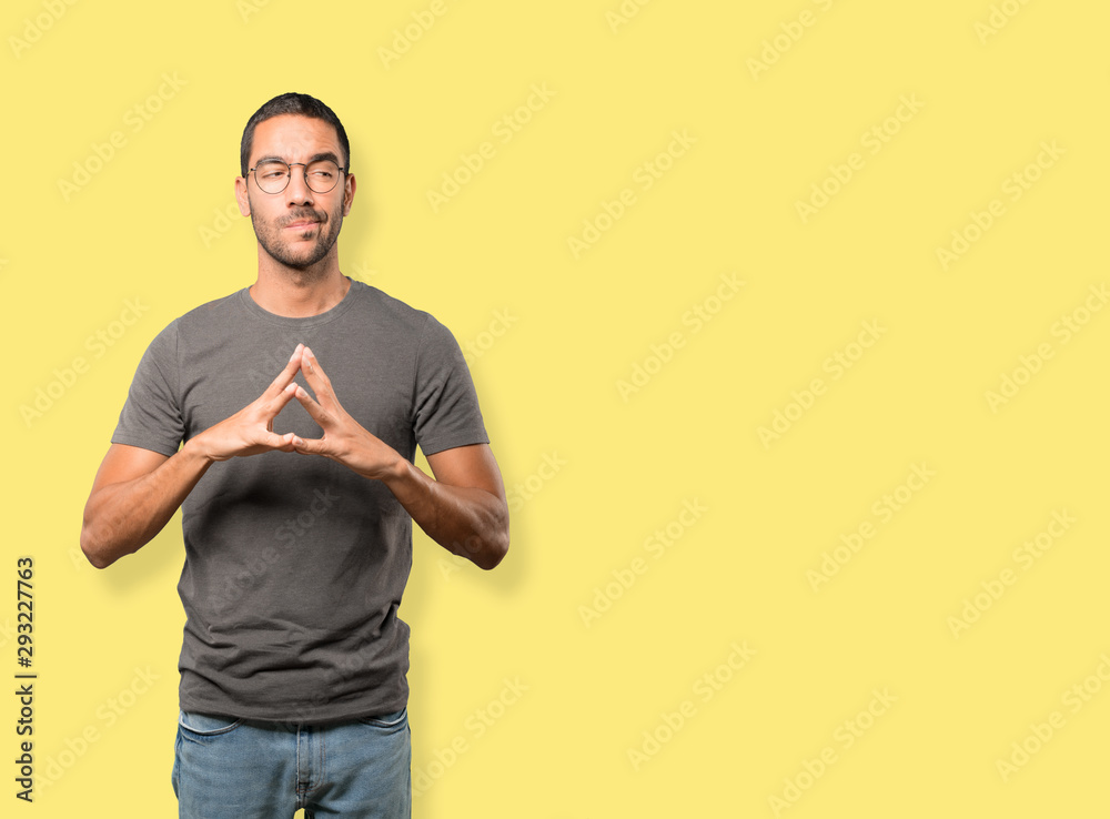 Serious young man doing a gesture of concentration Serious young man doing a gesture of concentration