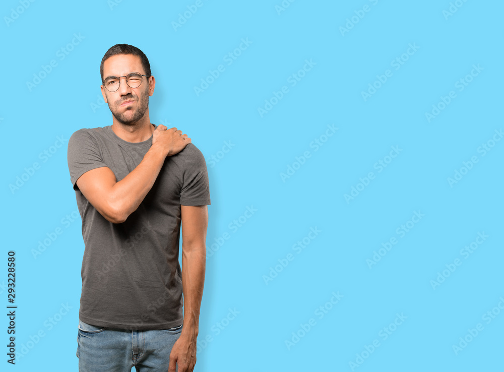 Fototapeta premium Concerned young man with a gesture of pain